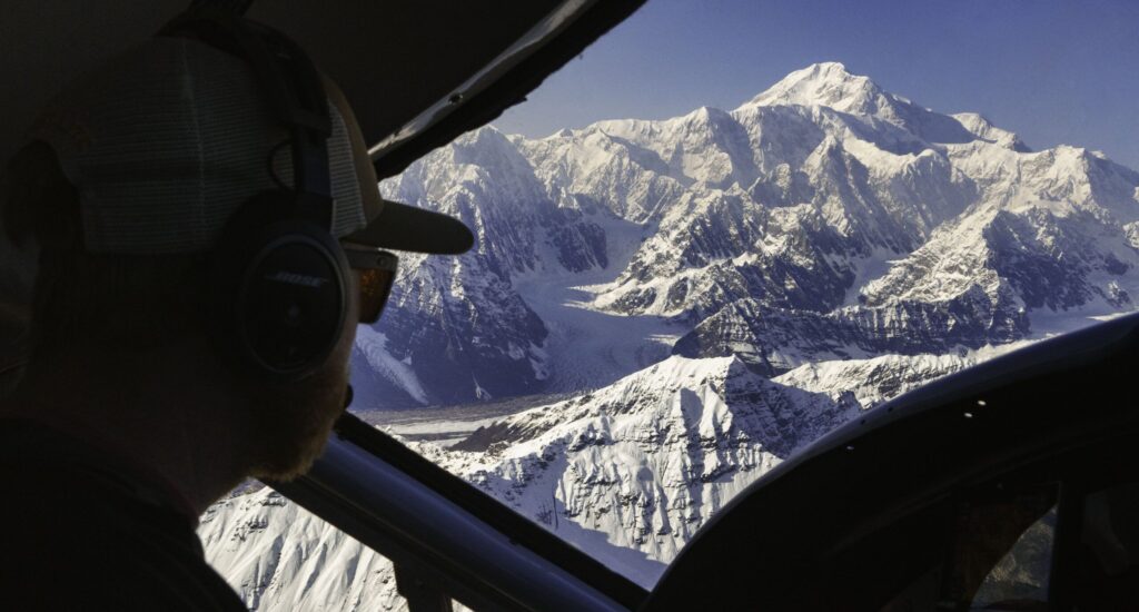 Pilot navigates Denali National Park via airplane with the summit in the background