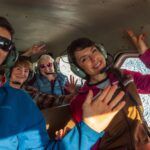Tourists sightseeing inside a plane with glacier out the window